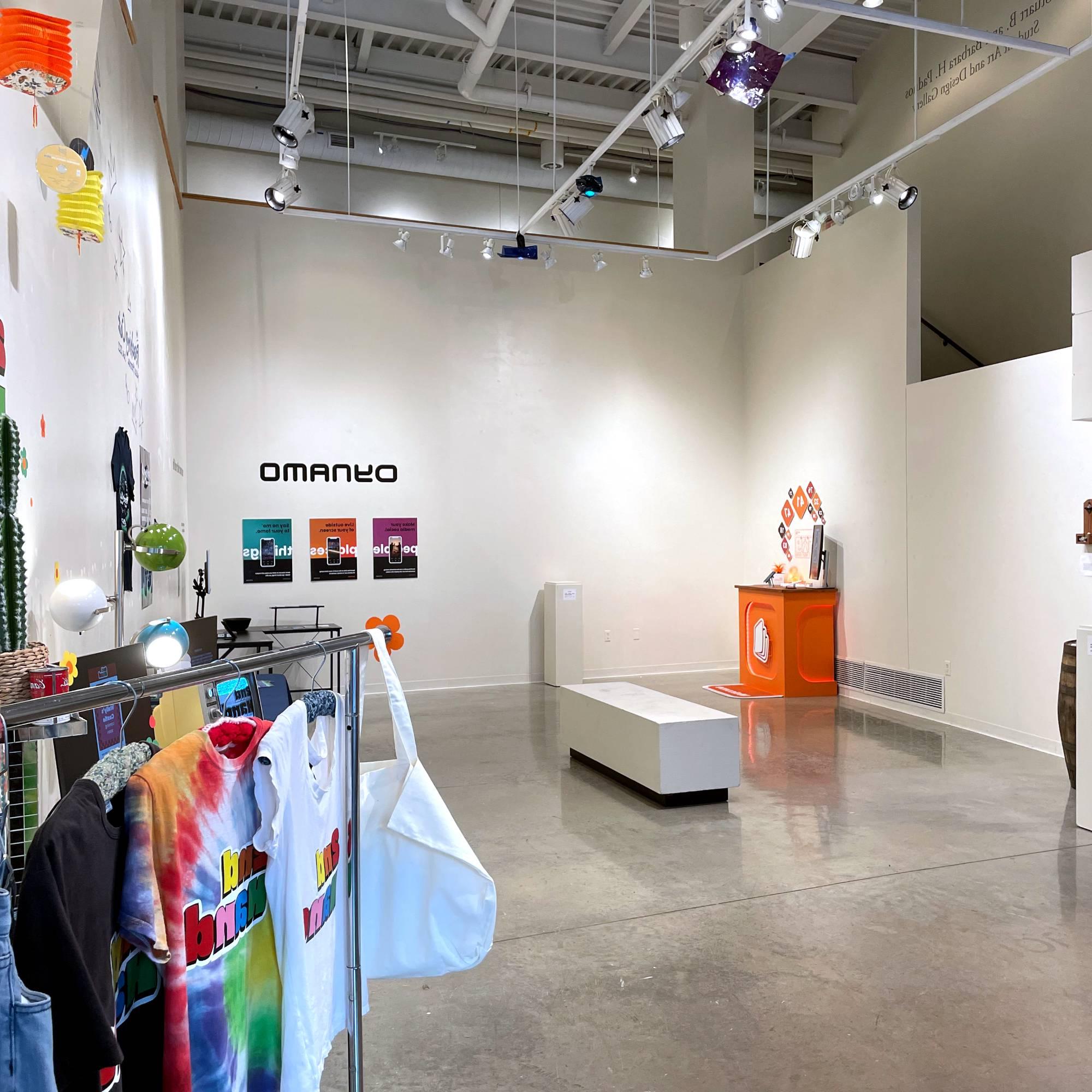 Brightly colored clothing BFA Graphic Design displays within the Padnos Student Gallery.